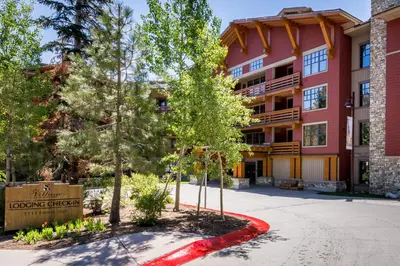 a large red building with trees in front of it at Village 1402 in Mammoth Lakes