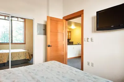 a bedroom with a bed and a flat screen tv at Village 2105 in Mammoth Lakes