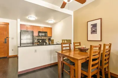 a kitchen and dining room with a wooden table and chairs at Village 3311 in Mammoth Lakes