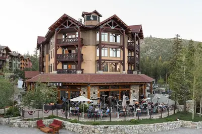 a large building with people sitting outside of it at Village 3311 in Mammoth Lakes