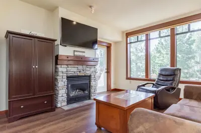 a living room with a couch and a fireplace at Village 3321 in Mammoth Lakes