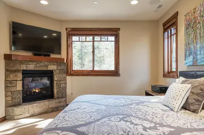 a bedroom with a bed and a fireplace at Gray Bear 514 in Mammoth Lakes