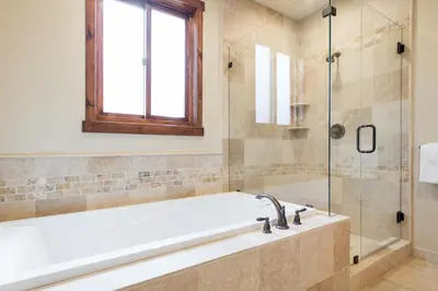 a bathroom with a tub and a glass shower at Gray Bear 514 in Mammoth Lakes
