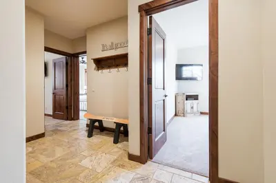 a hallway with a door and a bench in a room at Gray Bear 514 in Mammoth Lakes