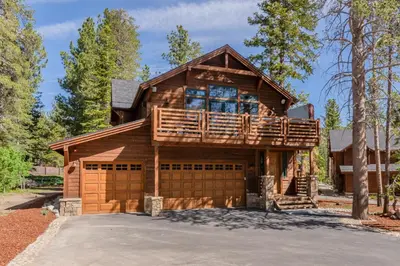 a large wooden house with a balcony and a garage at Gray Bear 514 in Mammoth Lakes