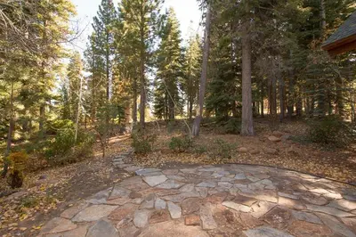 a stone walkway in the middle of a forest at Northstar - Sierra Gold Home in Kingswood Estates