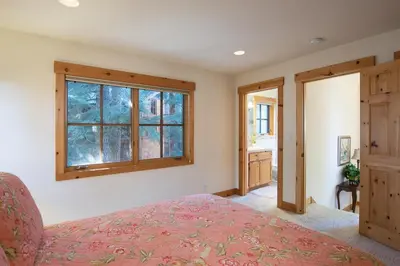 a bedroom with a bed and a window at Northstar - Sierra Gold Home in Kingswood Estates