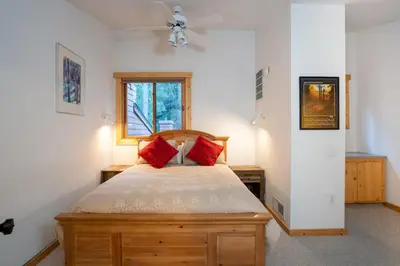 a bedroom with a bed with red pillows on it at Northstar - Ski Trail Condo in Kingswood Estates