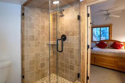 a shower with a glass door in a bathroom at Northstar - Ski Trail Condo in Kingswood Estates