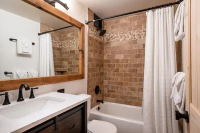 a bathroom with a sink and a toilet and a tub at Northstar - Ski Trail Condo in Kingswood Estates