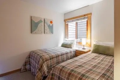 a bedroom with two beds and a window at Northstar - Ski Trail Condo in Kingswood Estates