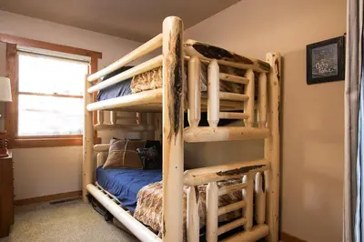 a wooden bunk bed in a room with a bunk bed at North Shore - Dancing Antler in Wood Vista