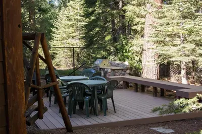 a deck with tables and chairs and a picnic table at North Shore - Dancing Antler in Wood Vista