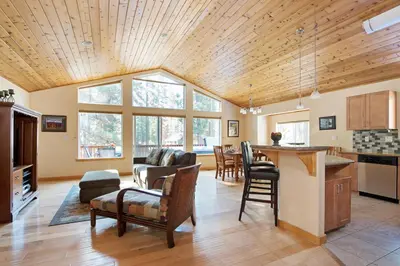 a kitchen and living room with a wooden ceiling at North Shore - Golden Pine in Kings Beach