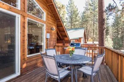 a table and chairs on a deck in a cabin at North Shore - Golden Pine in Kings Beach