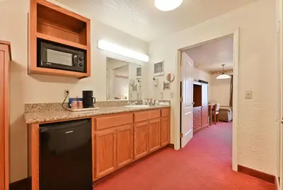 a kitchen with a sink and a microwave at Murphys Suites in Murphys