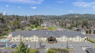 an aerial view of a hotel with a parking lot at Murphys Suites in Murphys