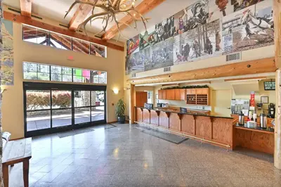 a lobby of a restaurant with a large window at Murphys Suites in Murphys