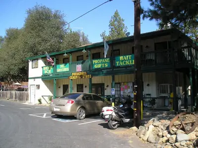 a car parked in a parking lot in front of a building at Ponderosa Camping Resort One-Bedroom Cabin 4 in Lotus