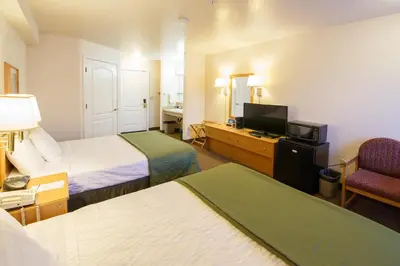 a hotel room with two beds and a television at Murphys Inn Motel in Murphys