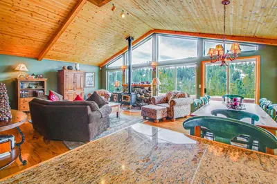 a living room with a large room with a table at Hillside View Home in Truckee
