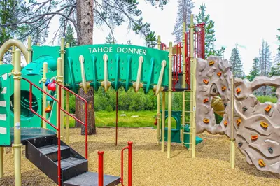 a playground with a slide and a play structure at Hillside View Home in Truckee