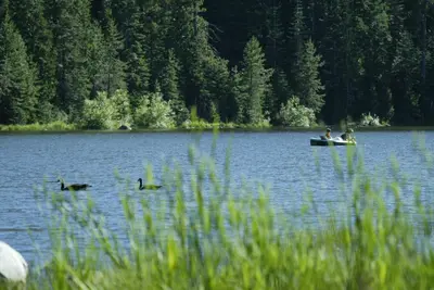 a group of people in a boat on a lake at Snowflower Camping Resort 16 ft. Yurt 10 in Emigrant Gap