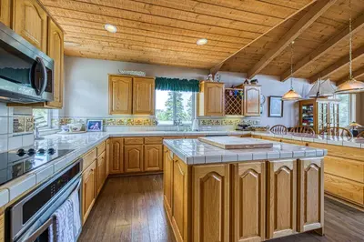 a large kitchen with wooden cabinets and a wooden ceiling at White Pines Mountain Lodge #7 in Mammoth Lakes