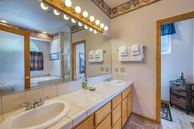 a bathroom with two sinks and a large mirror at White Pines Mountain Lodge #7 in Mammoth Lakes