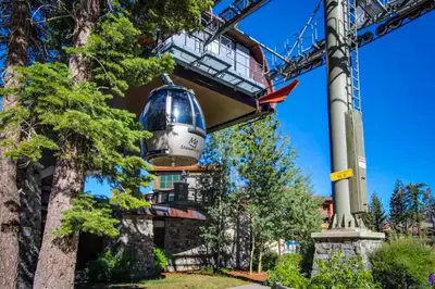 a bucket hanging from a crane in front of a building at White Pines Mountain Lodge #7 in Mammoth Lakes