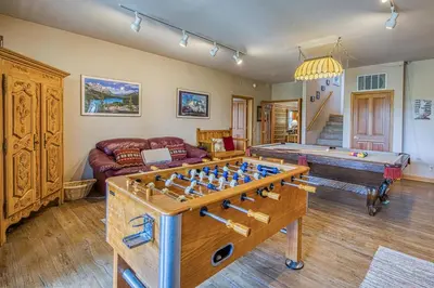 a living room with a game table and a couch at White Pines Mountain Lodge #7 in Mammoth Lakes