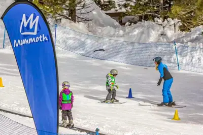 a group of three people skiing in the snow at White Pines Mountain Lodge #7 in Mammoth Lakes