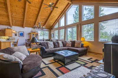 a living room with leather furniture and large windows at White Pines Mountain Lodge #7 in Mammoth Lakes