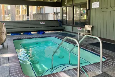 a swimming pool with a hot tub in a house at Sunshine Sanctuary in Mammoth Lakes
