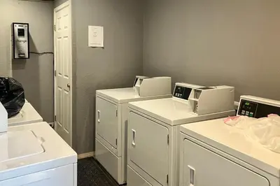 a laundry room with three washer and dryers at Sunshine Sanctuary in Mammoth Lakes