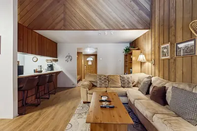 a living room with a couch and a table at Sunshine Sanctuary in Mammoth Lakes
