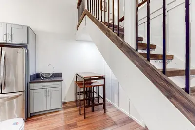 a kitchen with a staircase and a kitchen with a table at Sierra Manors 145 in Mammoth Lakes