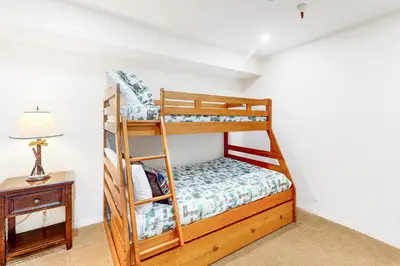 a bedroom with two bunk beds and a table at The Bridges 203 in Mammoth Lakes