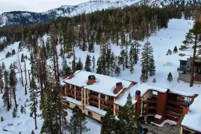 a building with a hot tub on the roof in the snow at The Bridges 203 in Mammoth Lakes
