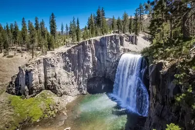 an aerial view of a waterfall on a rocky mountain at The Bridges 203 in Mammoth Lakes