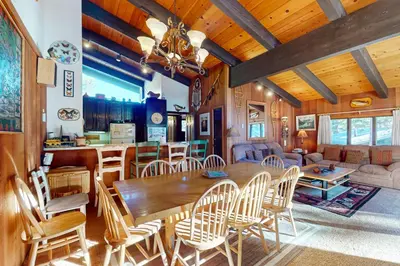a dining room and living room with a table and chairs at Chateau Sans Nom 31 in Mammoth Lakes