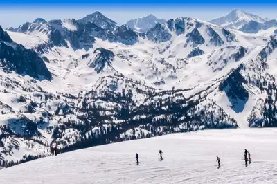 a group of people skiing down a snow covered mountain at Chateau Sans Nom 31 in Mammoth Lakes