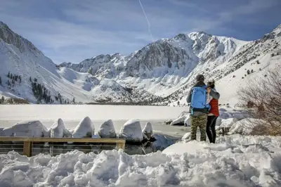 two people flying a kite in the snow at Discovery 4 162 in Mammoth Lakes