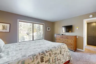 a bedroom with a bed and a window and a dresser at Discovery 4 162 in Mammoth Lakes