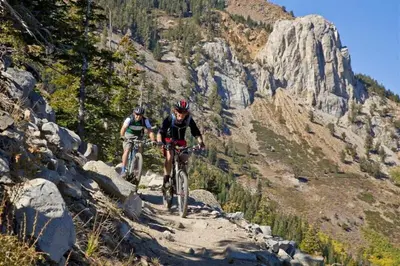 two people riding bikes on a mountain trail at Eagle Run 107 in Mammoth Lakes