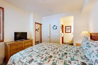 a bedroom with a bed and a tv on a dresser at Eagle Run 113 in Mammoth Lakes