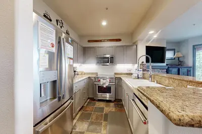 a kitchen with stainless steel appliances and a sink at Eagle Run 206 in Mammoth Lakes