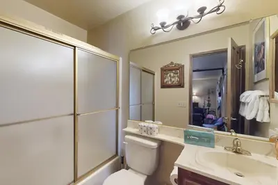 a bathroom with a toilet and a sink and a mirror at Forest Creek 22 in Mammoth Lakes