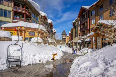 a street covered in snow next to buildings at Helios North in Mammoth Lakes