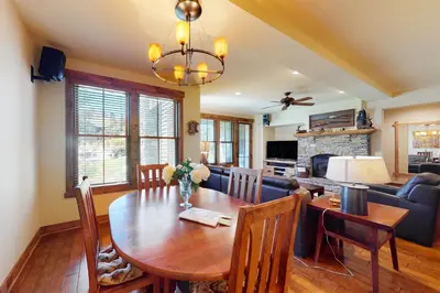 a dining room and living room with a wooden table at The Lodges 1145 in Mammoth Lakes